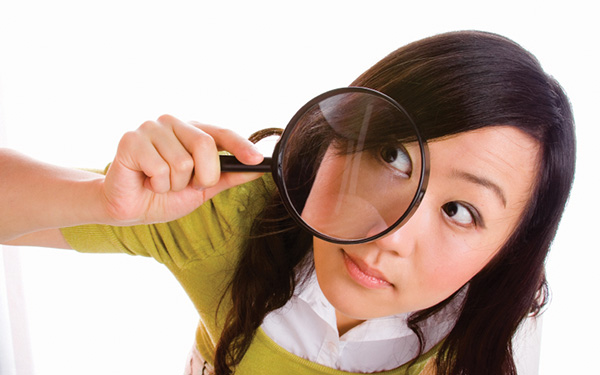 Female with magnifying glass